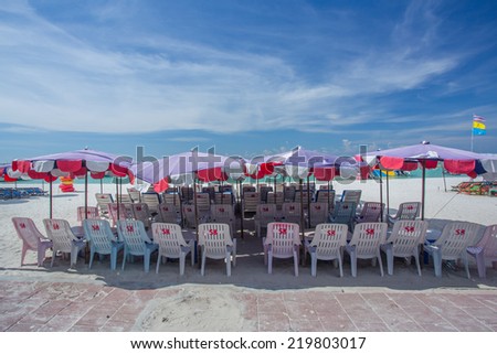lounge chairs with umbrella on a beach