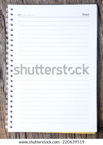 checked note paper isolated on wood