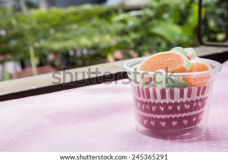 candies. jelly candies in cup on a background. jelly candies in bowl on a background.