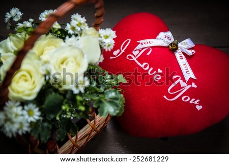 bouquet rose flower in a basket and pillow heart shape with text I love you, focus text i love you