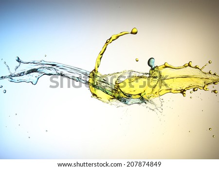 clash of yellow and blue liquid jets isolated in white background