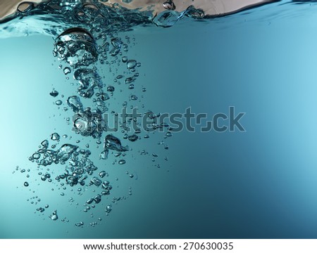 Blue underwater surface and air bubbles