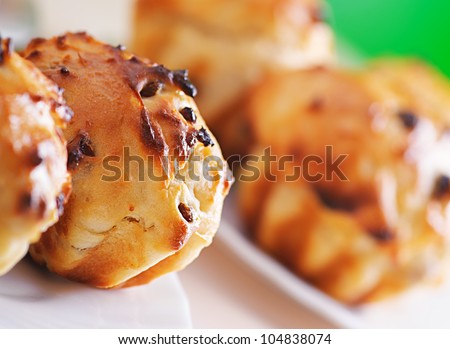 Small plates of muffins on background of green summer garden.