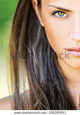 Portrait close up half of face young beautiful woman, on green background summer nature.