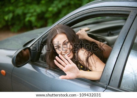Young woman with nice car on road.