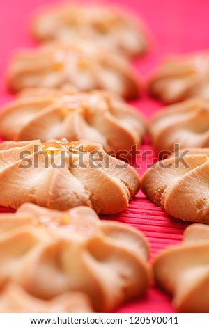 Freshly baked cookies on red bamboo napkin.