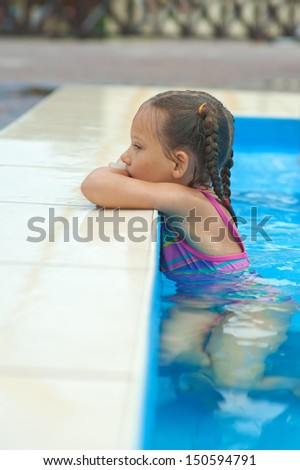 Beautiful little girl in pool water park.