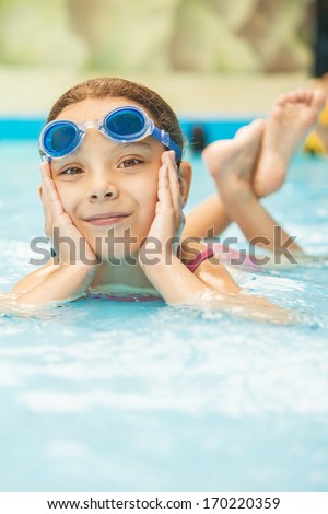 Beautiful little girl in pool water park.