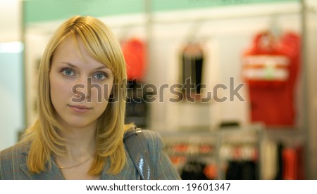 Portrait of the beautiful young woman in a lady\'s wear boutique