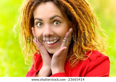 Young woman with dreadlocks with astonishment suffices face palms.