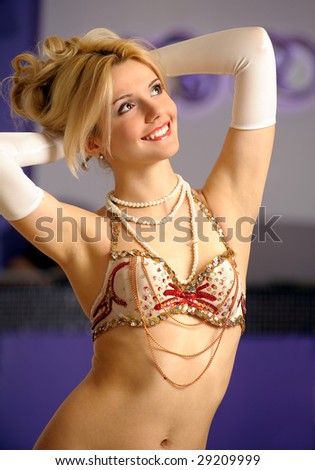 Young beautiful woman in dancing suit laughs.