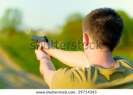 Man shoots at target.