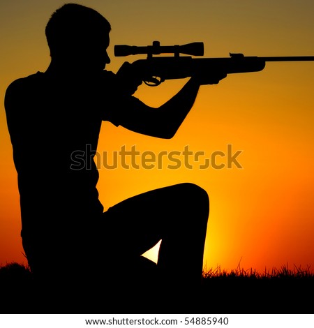 The man who shoots from a sniper rifle against a sunset.
