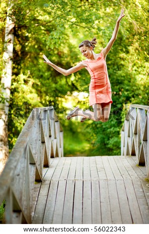 Jump girl on summer bridge in time vacation