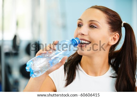 portrait of beautiful brunette girl drinking pure water 43