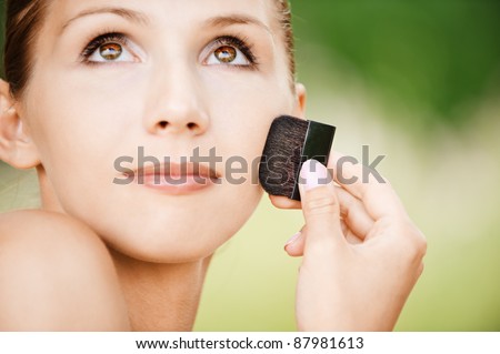 portrait bare charming brown-eyed young women face powders outdoors