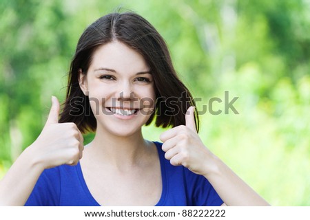 portrait beautiful young girl short hair park large finger smiles