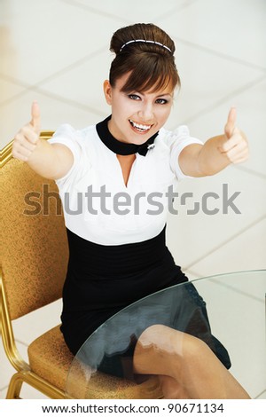 cheerful beautiful young woman sitting table stretches arms forward