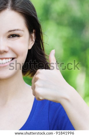 portrait half of face beautiful young girl short hair park large finger smiles