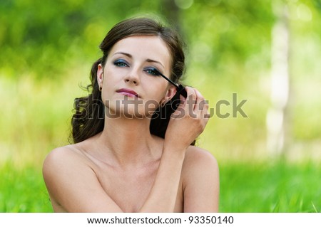 portrait charming young woman bare shoulders looks mirror imposes shadow background nature