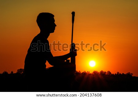 Rest of the sniper with a rifle against the coming sun