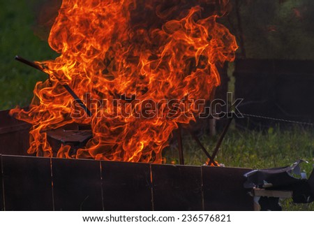 Fire burning in metal rusty container.