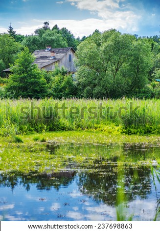 Wooden house near river in Central Russian Upland.