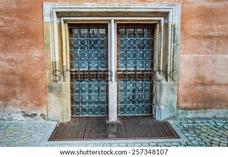 Window on an old European building with wrought iron bars.