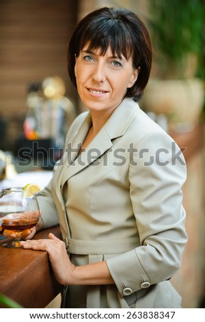 Beautiful business woman holding glass of wine at corporate events.