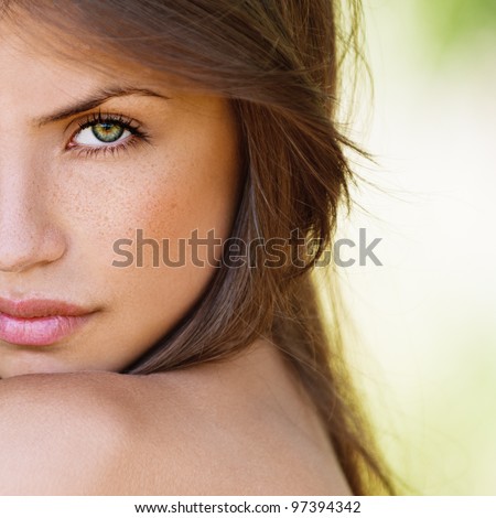 portrait half face of beautiful sexy girls with dark hair and bare shoulders seductively on green background