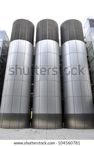 Three large air conditioning tubes outside modern building