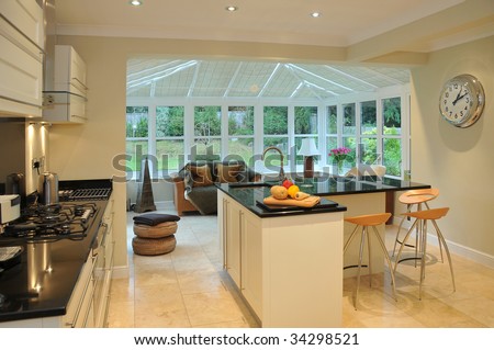 Interior of a modern kitchen with beyond a conservatory and garden