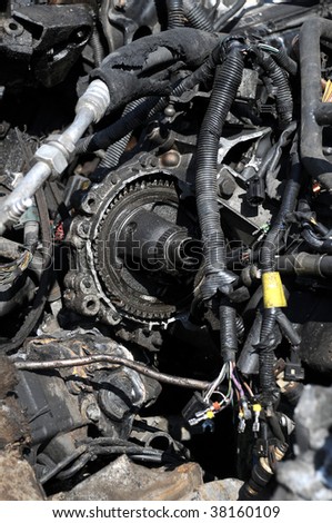 Close up of scrap car parts made up of metal, electrical, and piping
