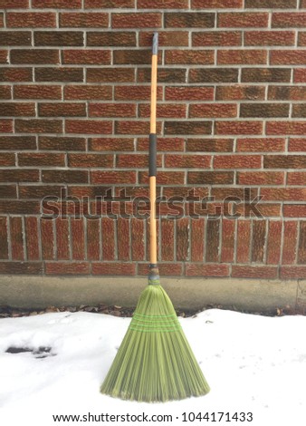 Here is an old broom waiting outside for spring cleaning