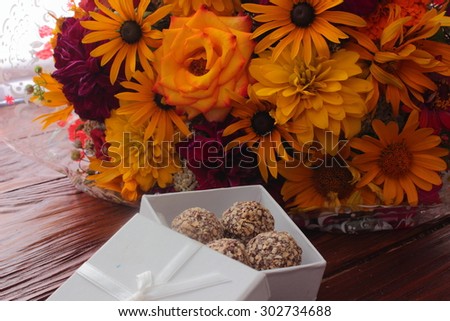 nice dessert in the form of chocolates and decorated with flowers