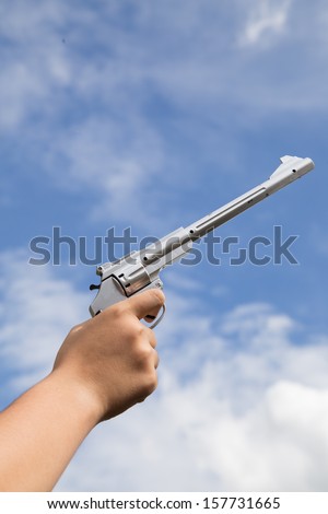 gun in hand and sky