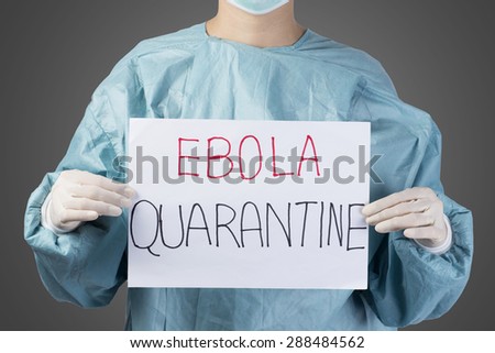 scientist in safety suit drawing word ebola quarantine