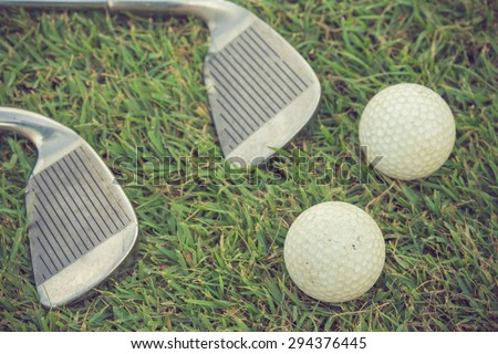 Golf club and ball in grass vintage color