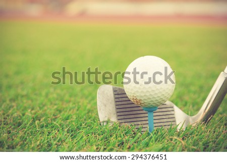 Golf club and ball in grass vintage color