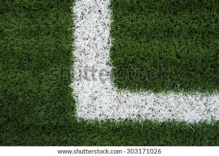 Photo of a green synthetic grass sports field with white line shot