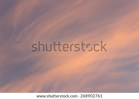 Background texture purple sky at sunset with orange and pink windy clouds