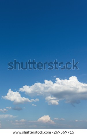Blue sky, with white clouds at the bottom and clean top. Summer day, sky without sun, space for text