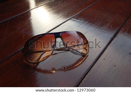 Brown Sun glass on wood desk