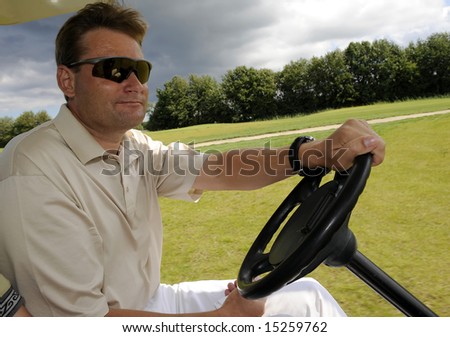 Golf player driving with cart on golf course