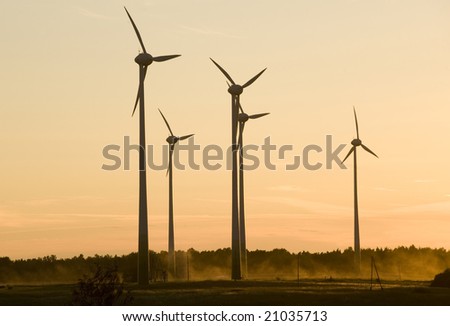 wind farm turbines generators rows at dusk