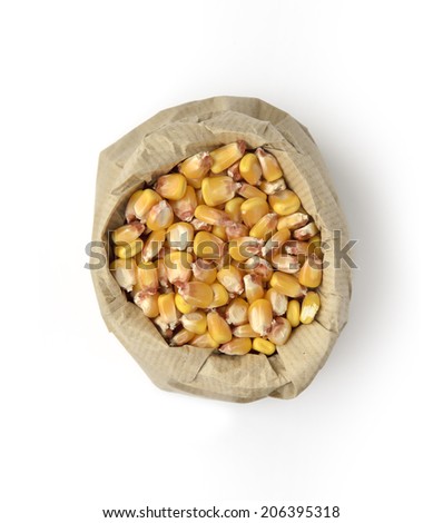 Corn seeds in paper bag isolated on white background. Above view.