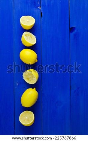 Multiple lemons over blue wooden background with copy space (negative space)
