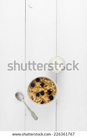 Bowl of cereals over white wooden table with copy space (negative space)