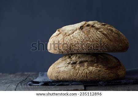 Traditional round bread over dark wooden table