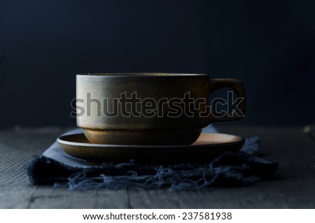 Brown coffee mug over dark blue cloth